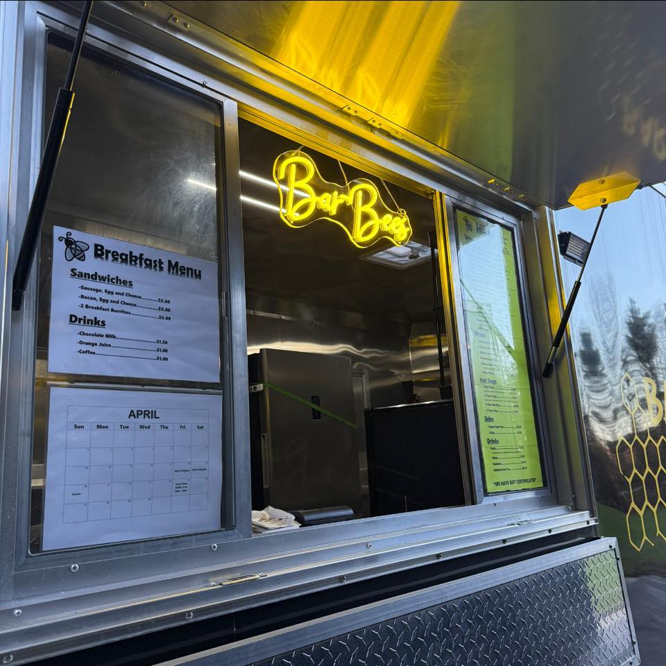 The Bar-Bees Lunchbox serving window with its glowing yellow sign